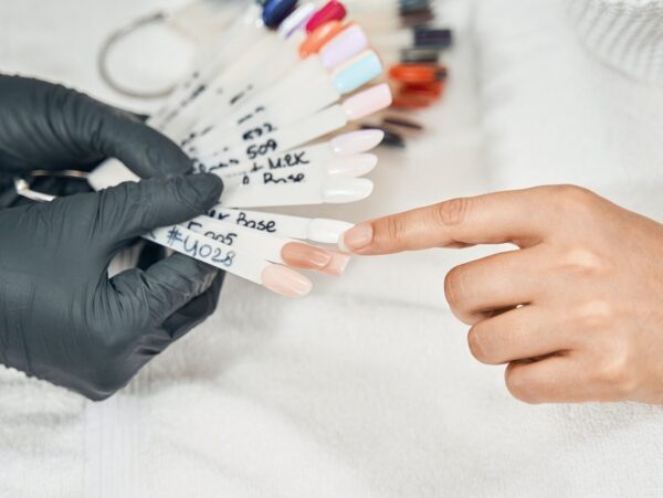 Close up of woman pointing at nude nail polish